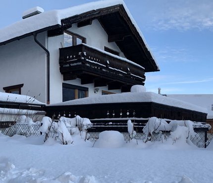 Haus Anemone © Familie Moncher Schneebedecktes Haus und Garten bei klarem Himmel