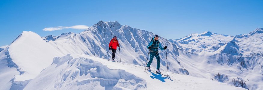 Winter holiday in SalzburgerLand © TVB Großarltal / Peter Maier Two ski tourers hiking on snow-covered mountain on a sunny winter day