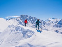 Grossarl Valley © TVB Großarltal / Peter Maier Two ski tourers hiking on snow-covered mountain on a sunny winter day